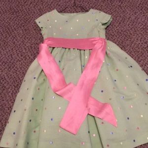 Green dress with poke dots and pink ribbon